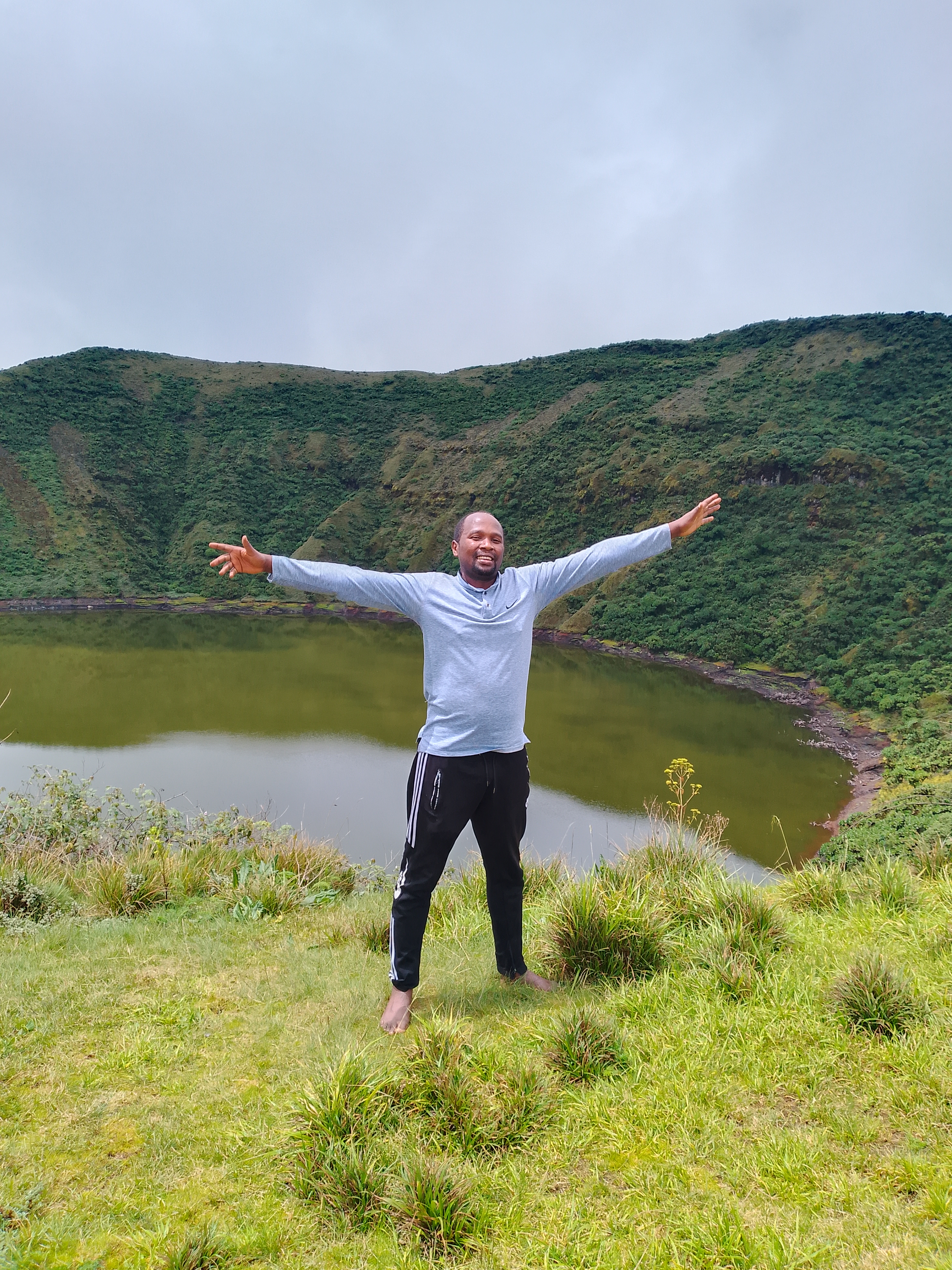 Faustin Gashakamba standing in a mountain landscape