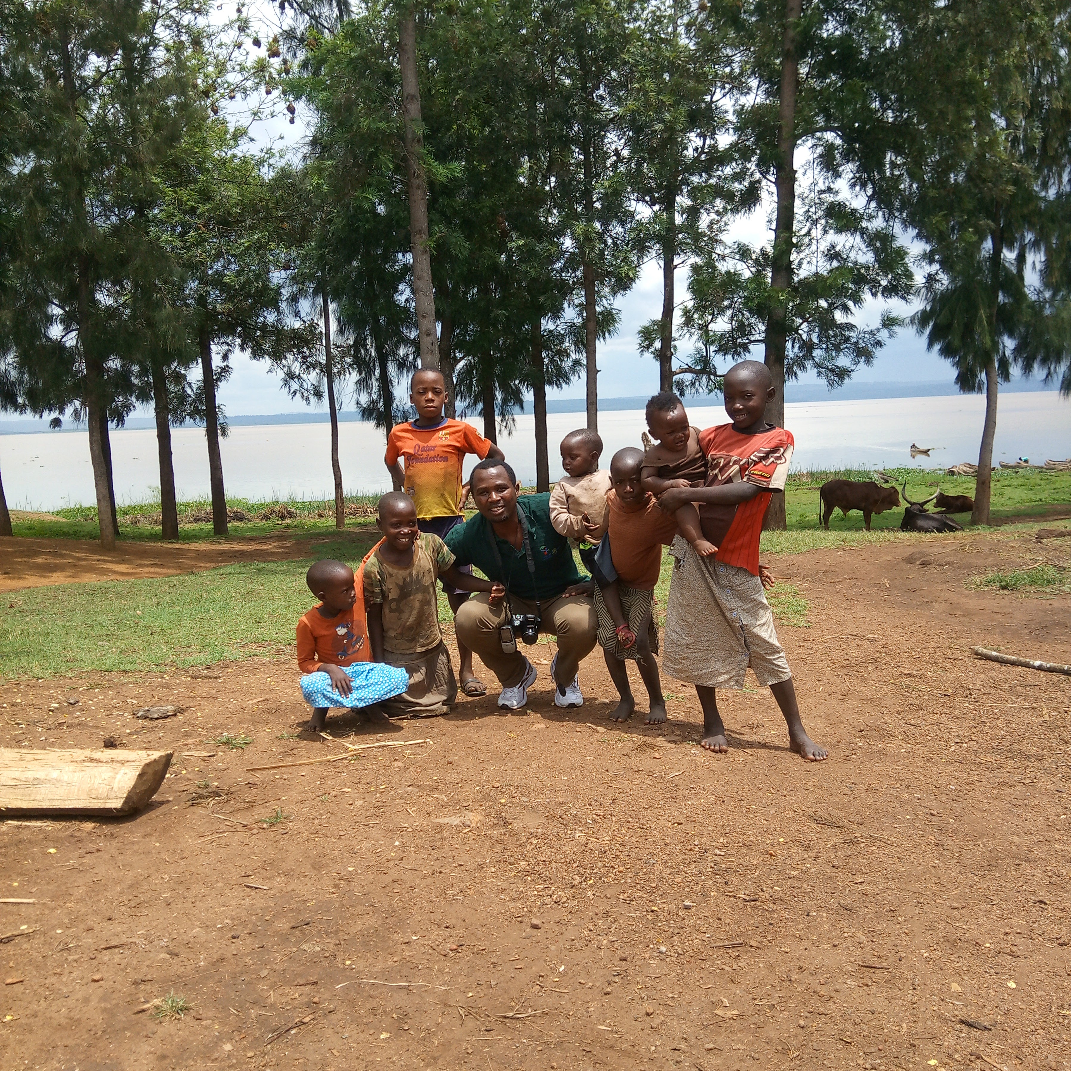 Faustin Gashakamba with children near a lake